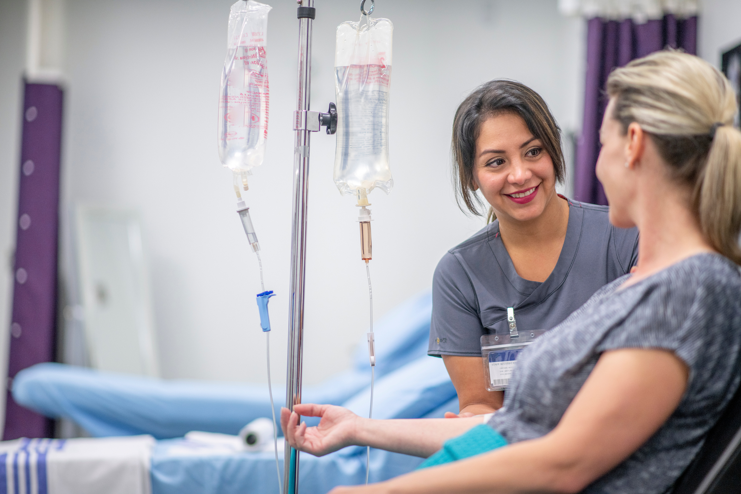 Nurse administering IV therapy to a patient